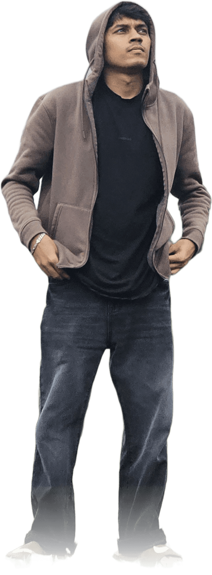 Adithya Hebbar, standing with hands in his jacket pockets, looking up and away from camera